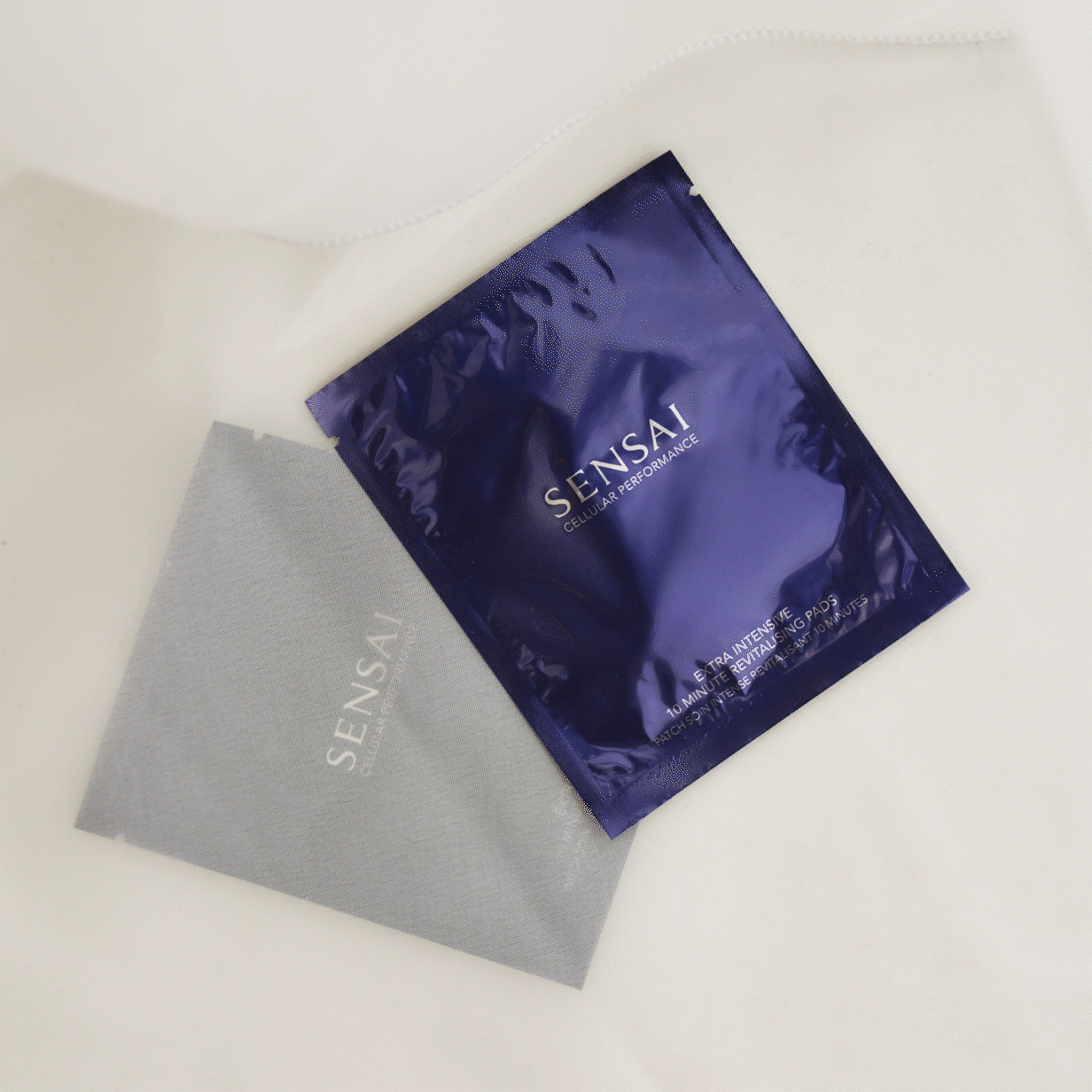 Cellular Performance Extra Intensive 10 Minute Revitalising Pads packaging shown on neutral background and pads shown on model's eye and mouth area